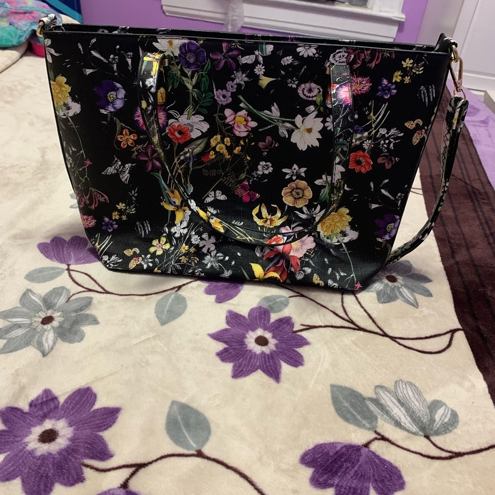This is a purse! It is black with colored flower🌸 It was never used.